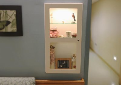 Display cases containing personal mementos are located outside each bedroom to help orient residents.